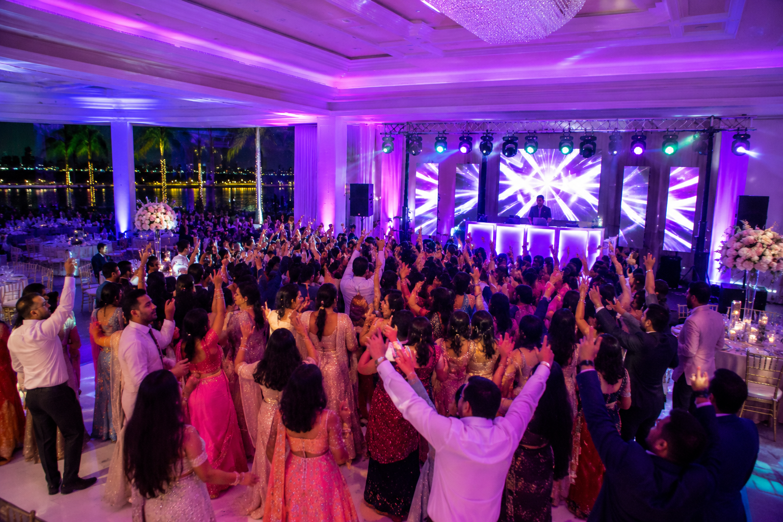 Packed dance floor at a waterfront Indian wedding reception